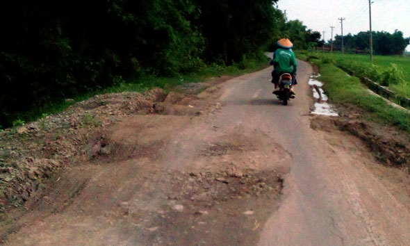 Penanganan jalan longsor di ruas Nganguk-Pentil Desa Gunungsari Kecamatan Kaliori menyisakan ceceran lumpur dari sisa material proyek. (Foto:Pujianto)
