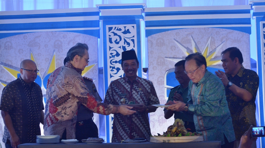 Plt Bupati Rembang Abdul Hafidz berada di tengah manajemen PT RSI dan PT SIR pada acara tasyakuran di tapak pabrik kedua perusahaan itu, Jumat (13/3/2015). (Foto: Pujianto) 
